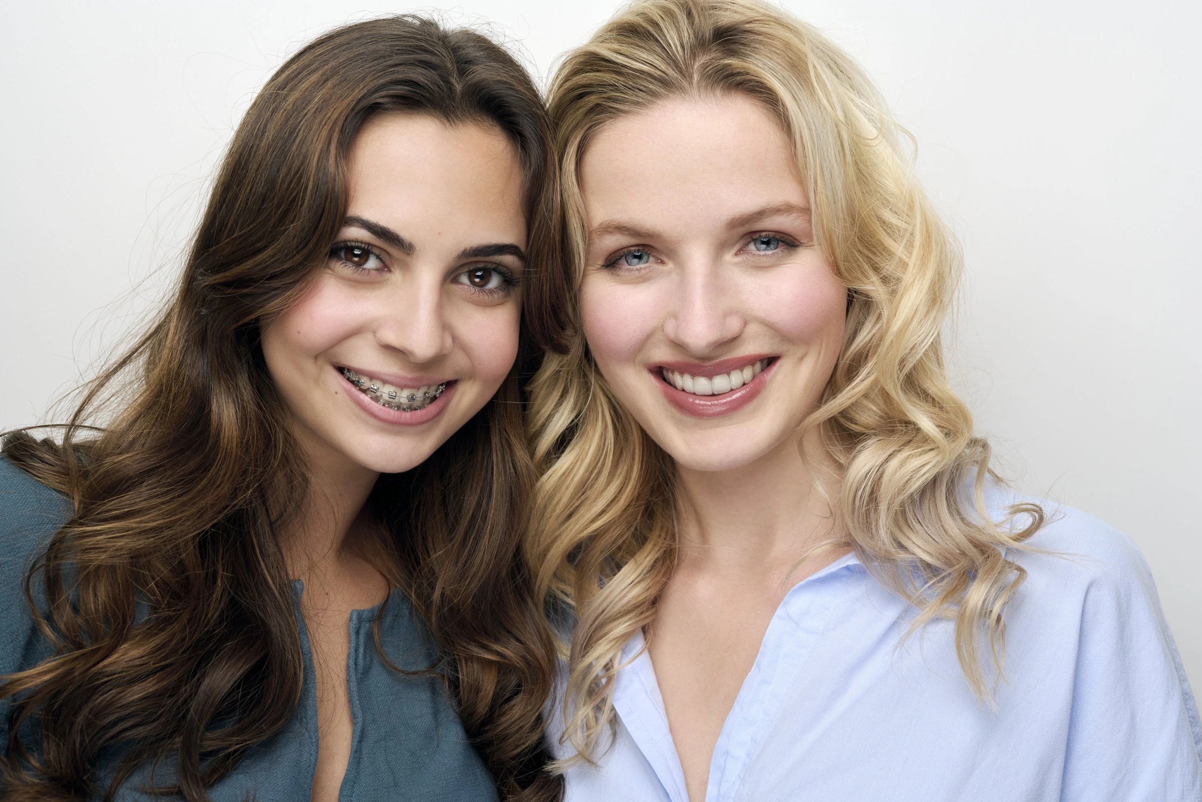 Zufriedene Patientinnen mit Zahnspange und strahlendem Lächeln